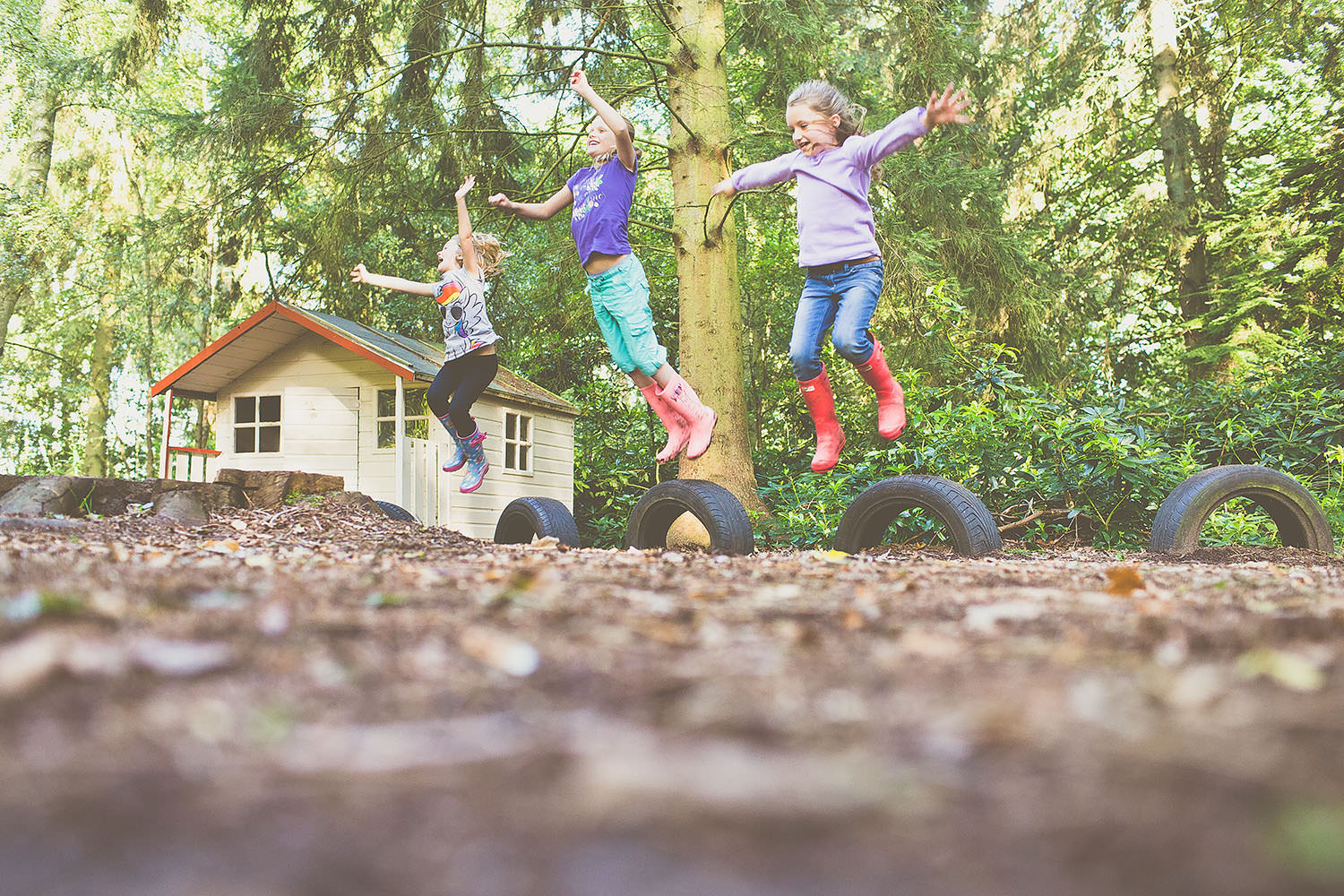 Three children jumping in the air.