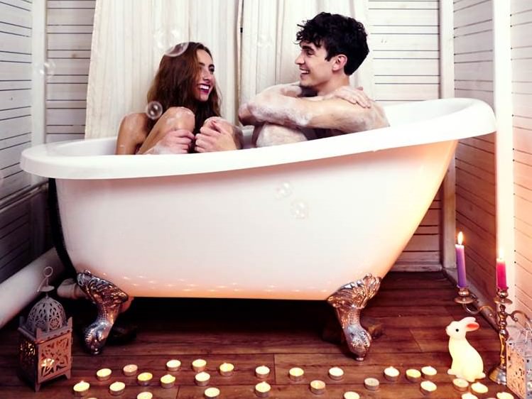 A couple sitting in a bath together