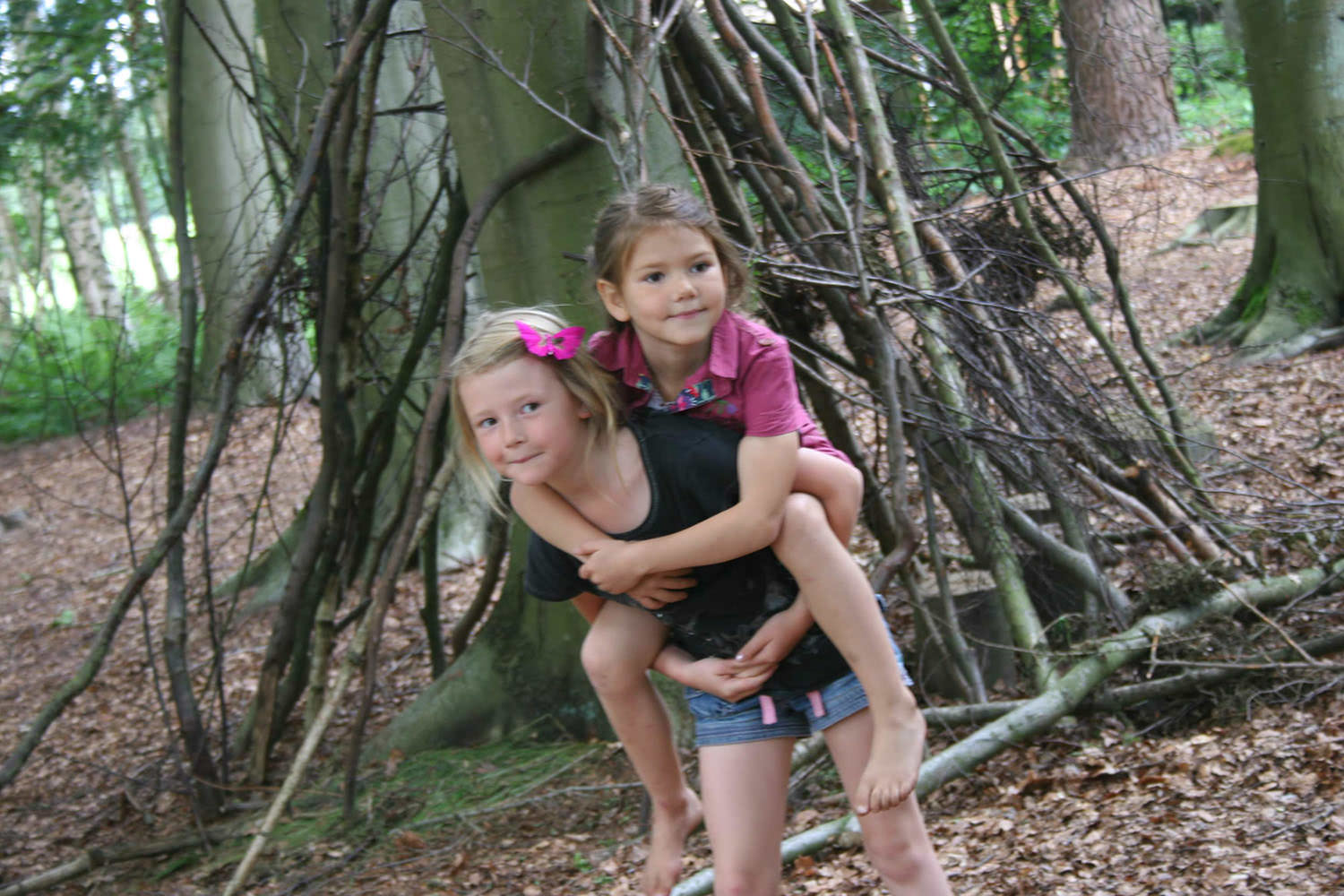 Two children playing in the woods.