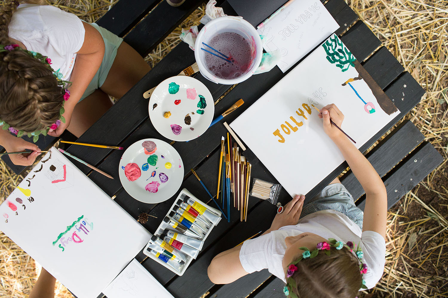 Two children painting pictures.