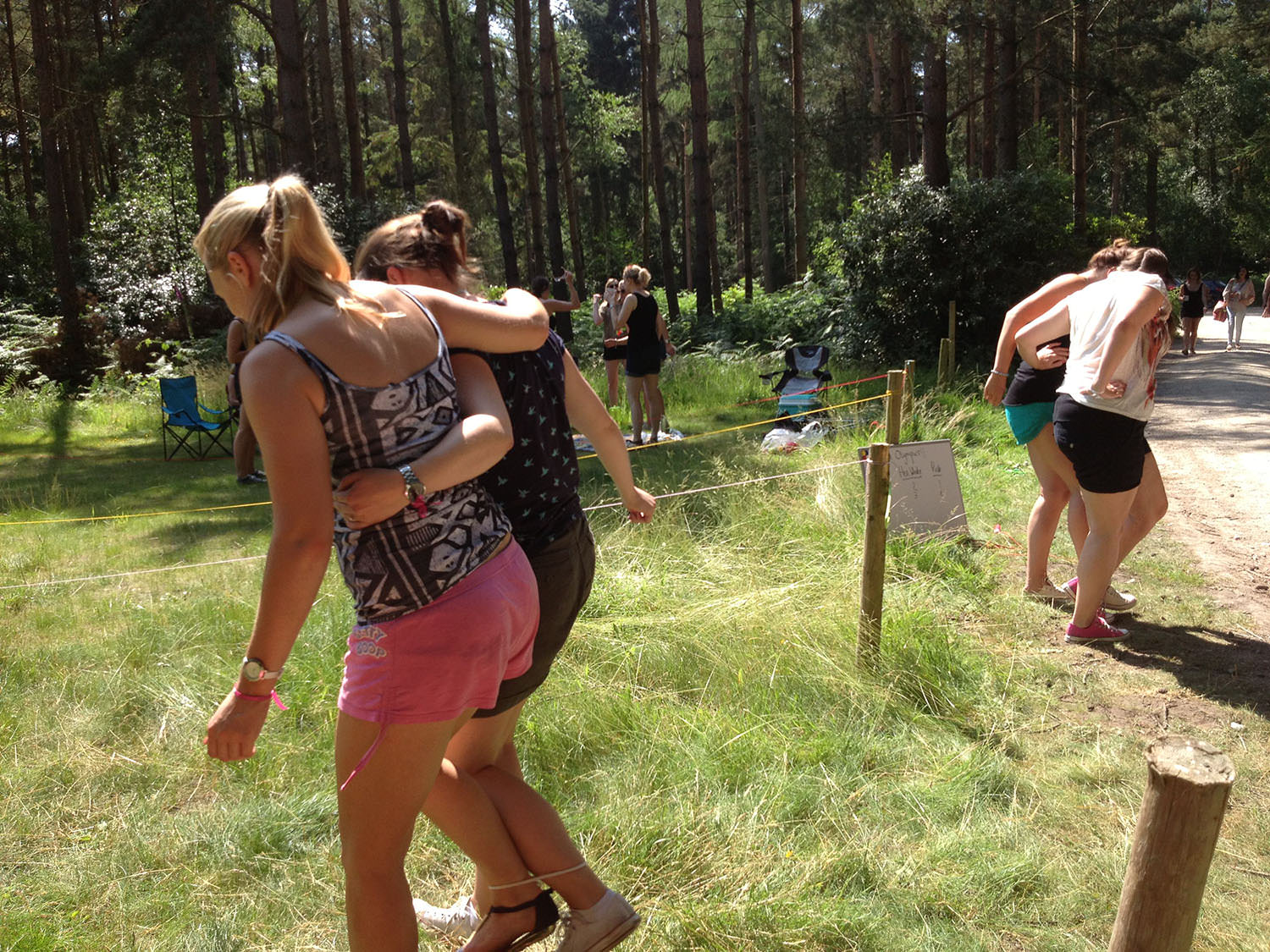 People having a three legged race.