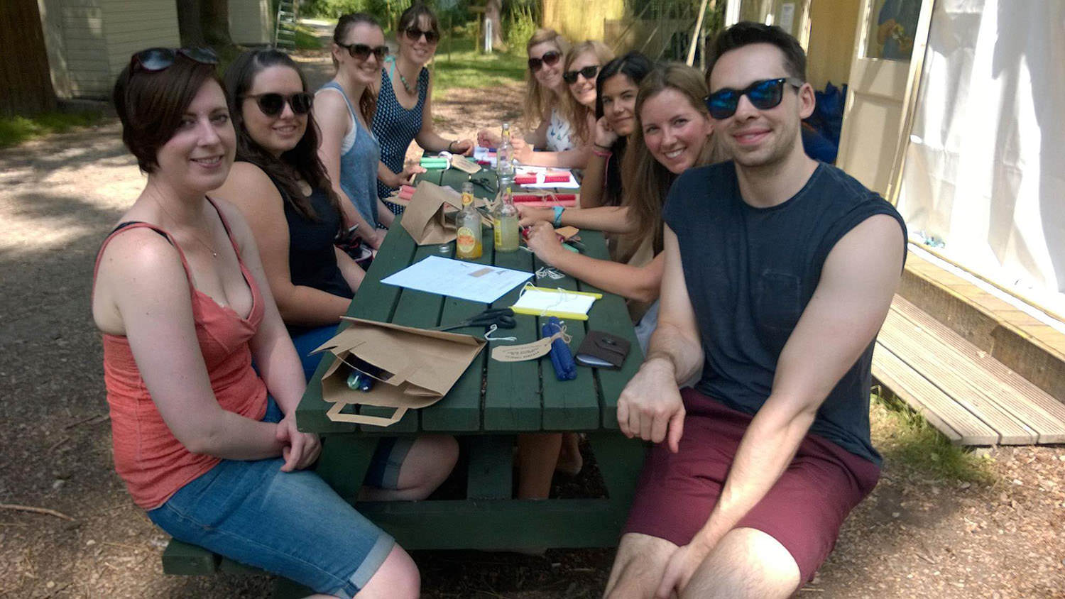 People smiling whilst sitting on a bench