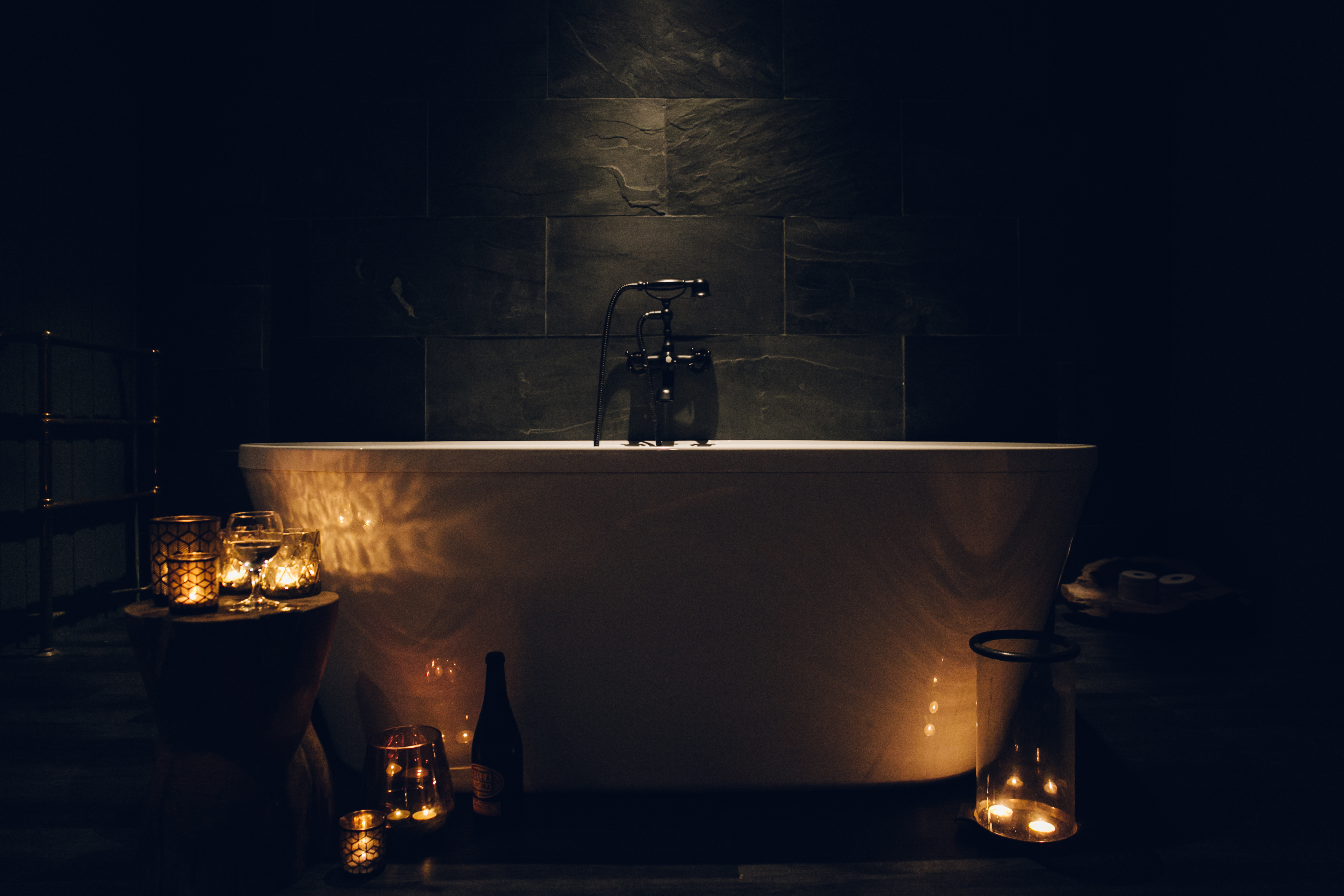 A candle lit bath in a cabin.